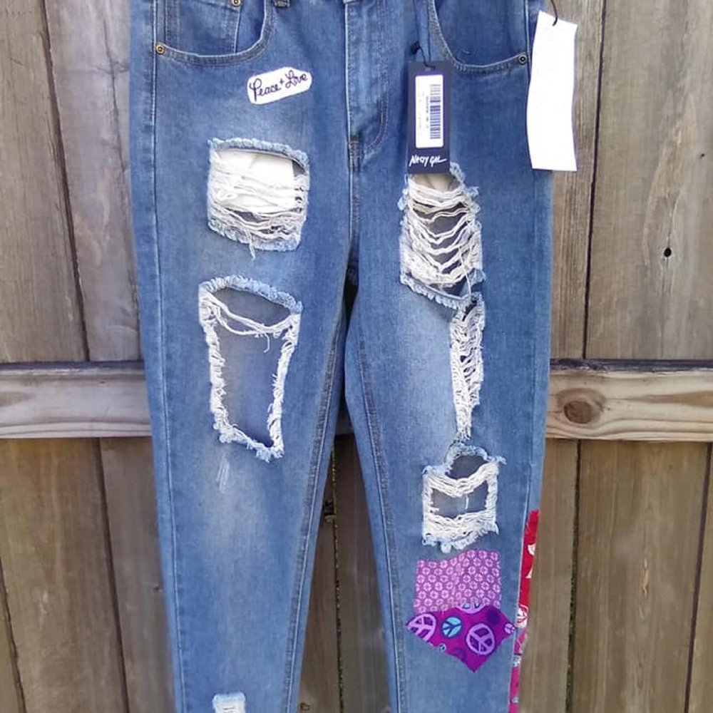Ladies Size 6 distressed/tattered boho denim jeans with garment tattoos.